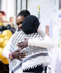 Sara Muzamil, JRS Australia Finding Safety Project Coordinator, shares a hug with a guest at our 