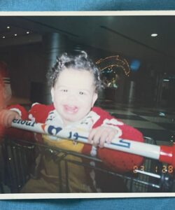 Batoul as a baby, in a supermarket trolley, shopping with her mum.